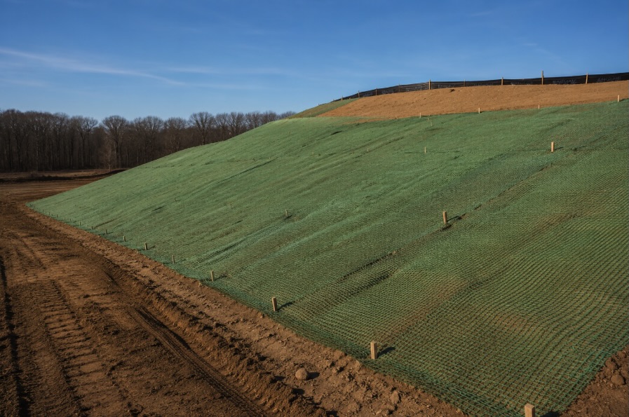 Erosion control blanket installed on a freshly graded embankment at a New Jersey construction site to prevent soil loss and slope erosion